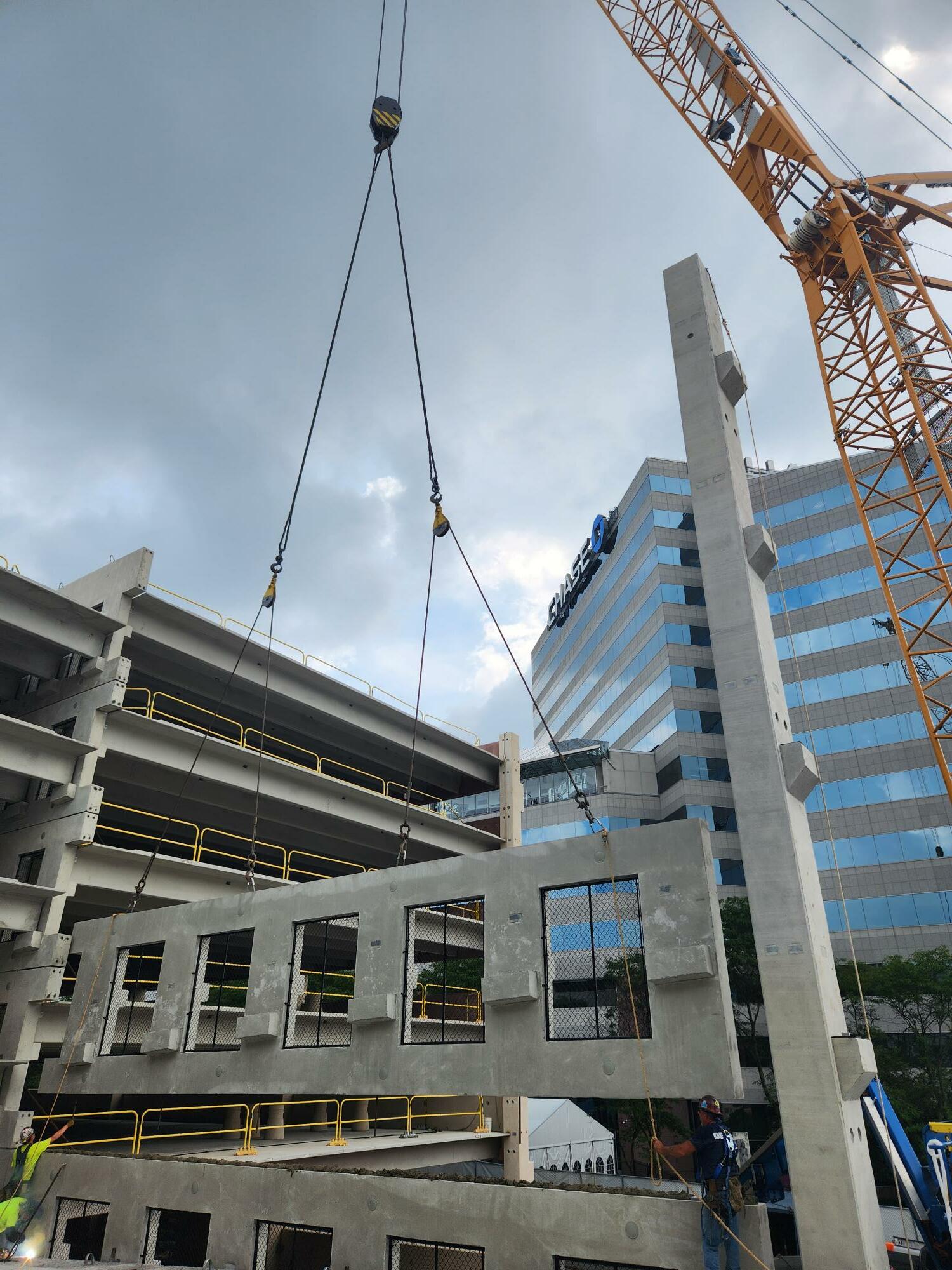 Construction crane piecing together a structure.