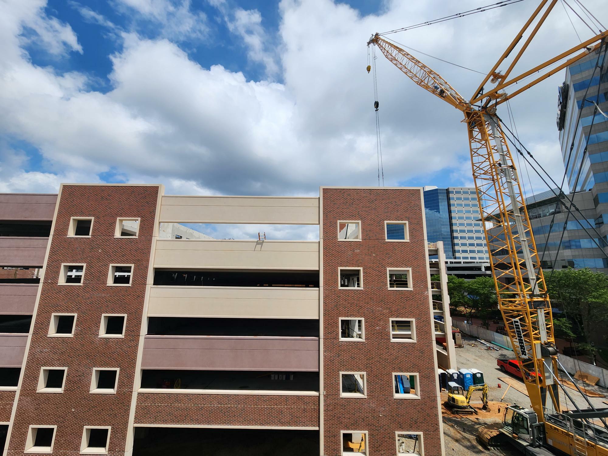 Parking Garage Structure under construction with a crane on the right side.