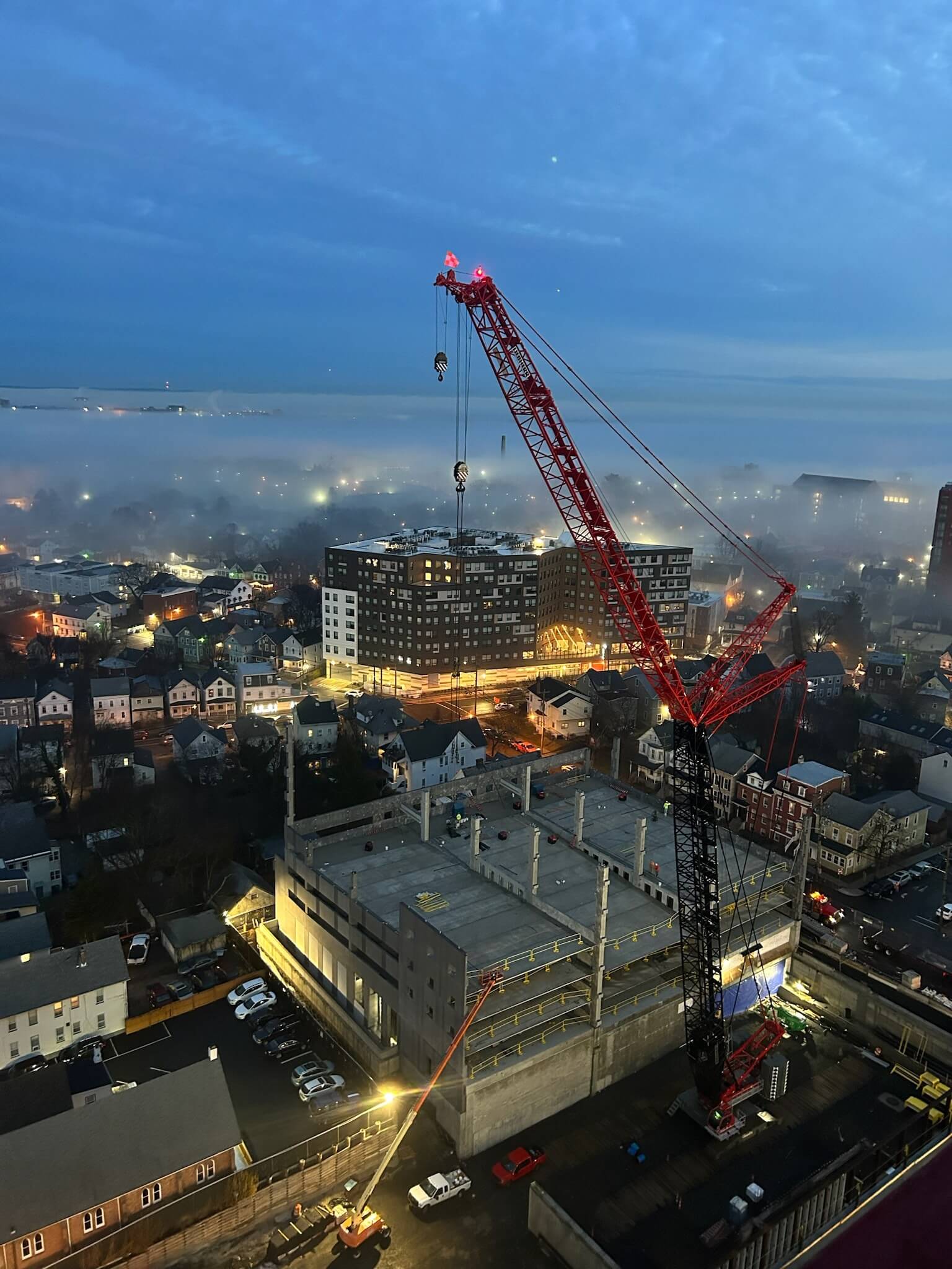 Aerial Night view of the Rutgers garage with a crane as the center of focus.