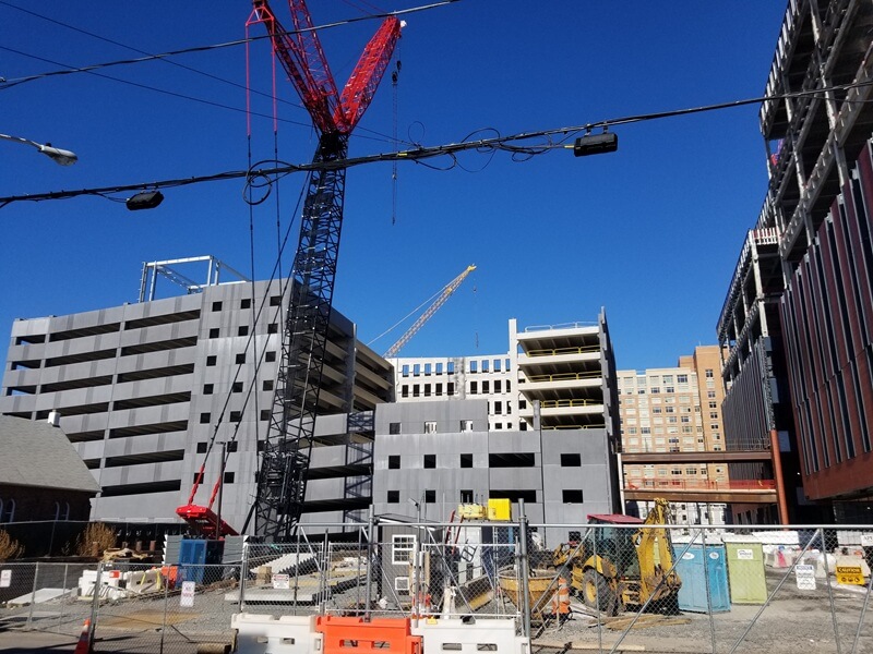 Crane behind a fenced area working on the Rutgers project.
