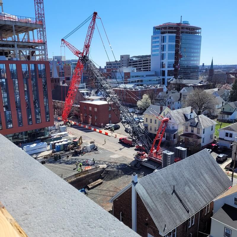 Crane being used within a tight confined urban area.