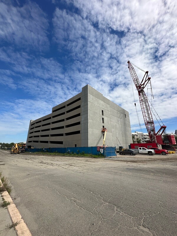Ground view of Point Liberte parking garage with crane in background.